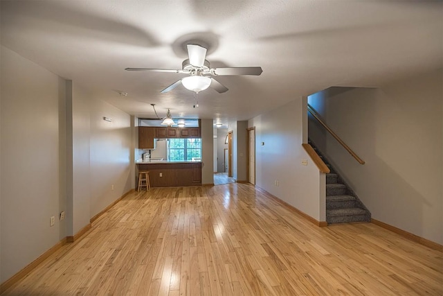 4119 Wood Hills Dr Unit C23, Erie, PA 16510 - unfurnished living room featuring light wood-style flooring, a ceiling fan, stairs, and baseboards