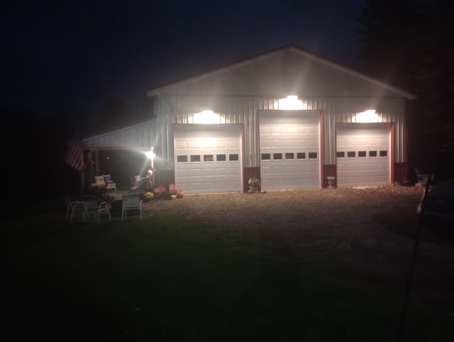 view of garage at twilight