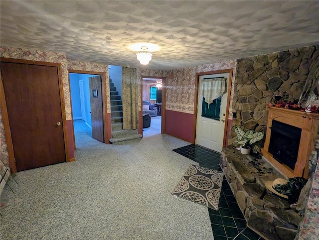 39501 Centerville Rd, Centerville, PA 16404 - entrance foyer featuring stairway, a textured ceiling, and a fireplace