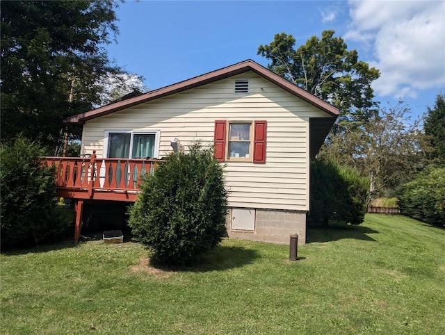 view of property exterior featuring a deck and a yard