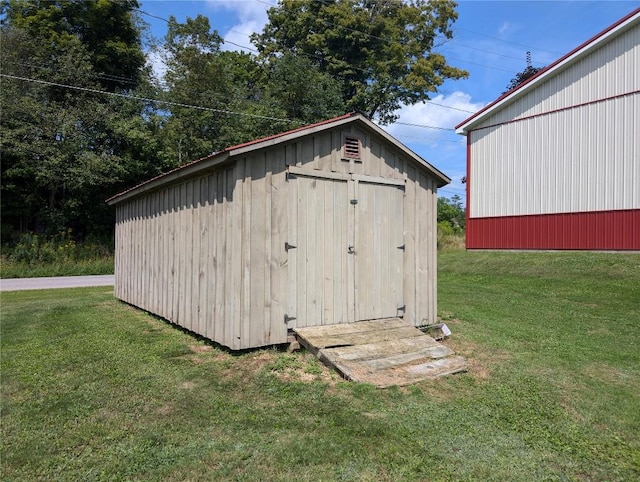 view of outdoor structure with a lawn