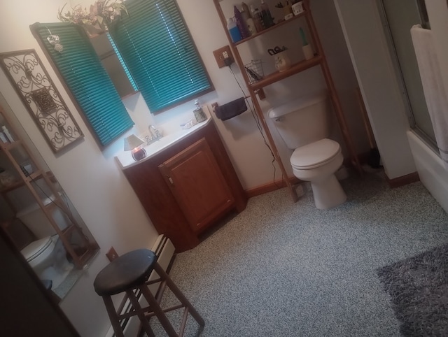 bathroom featuring bath / shower combo with glass door and toilet