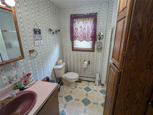 39501 Centerville Rd, Centerville, PA 16404 - bathroom with toilet, vanity, baseboard heating, and wallpapered walls