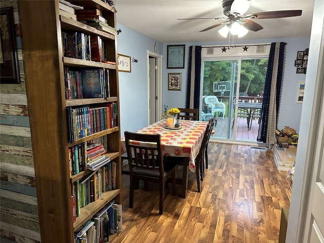 dining space with ceiling fan and wood-type flooring