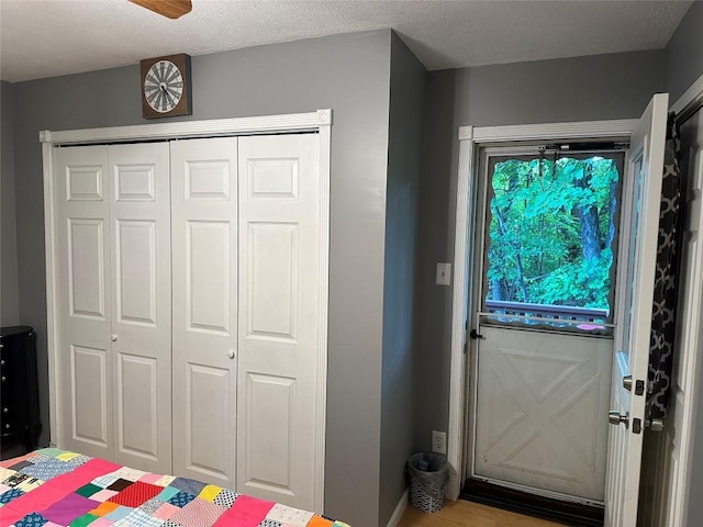 doorway with a textured ceiling