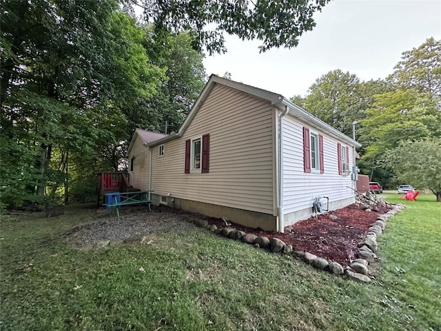 view of side of property with a yard