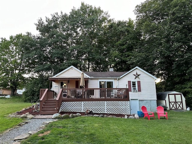 view of front facade featuring a front yard, a storage unit, and a wooden deck