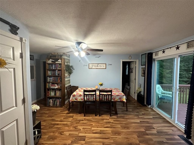 dining room featuring hardwood / wood-style floors, ceiling fan, and a textured ceiling