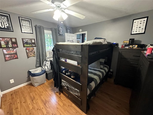 bedroom with ceiling fan and wood-type flooring