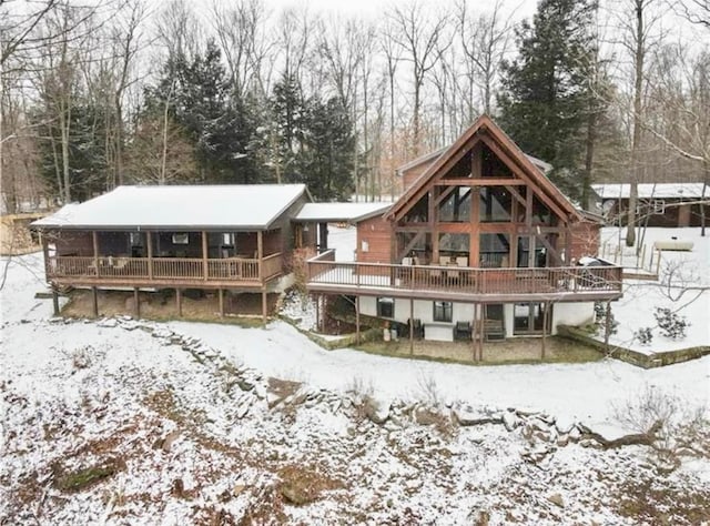 snow covered property with a deck