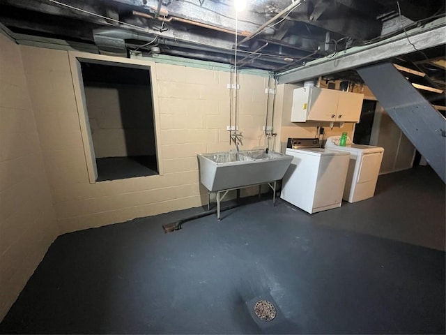 basement featuring washing machine and clothes dryer and sink