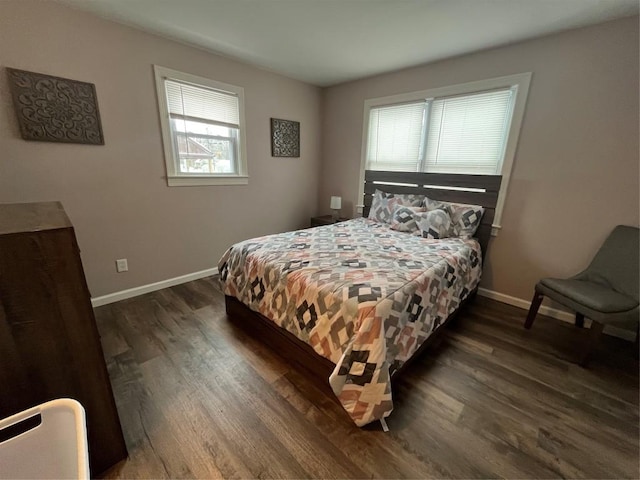 bedroom with dark hardwood / wood-style flooring