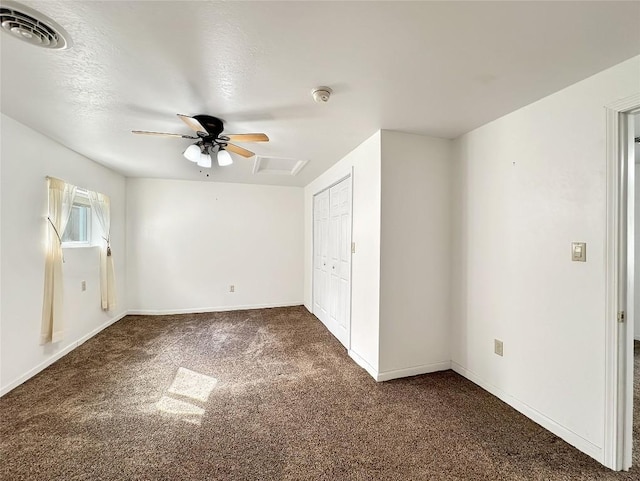 unfurnished bedroom with a ceiling fan, visible vents, carpet floors, and a closet