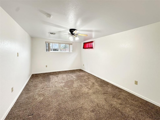 spare room with carpet floors, visible vents, baseboards, and ceiling fan