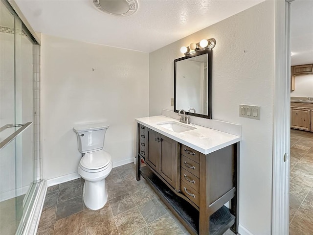 bathroom featuring baseboards, vanity, a shower stall, and toilet