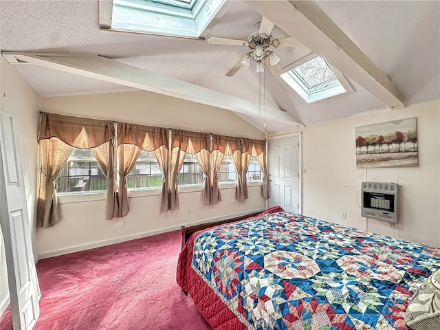 bedroom with lofted ceiling with skylight, multiple windows, heating unit, and carpet