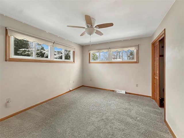 unfurnished bedroom featuring carpet floors, a closet, and ceiling fan