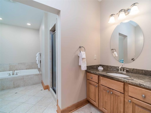 bathroom with tile patterned floors, separate shower and tub, and vanity