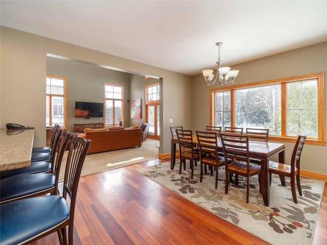 dining room featuring a notable chandelier and light hardwood / wood-style floors