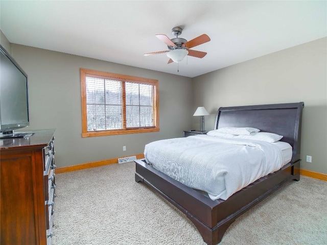 bedroom featuring light colored carpet and ceiling fan