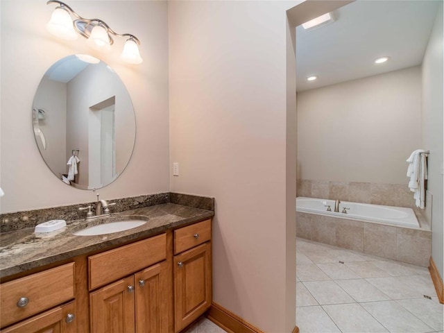 bathroom with vanity, tile patterned floors, and tiled bath