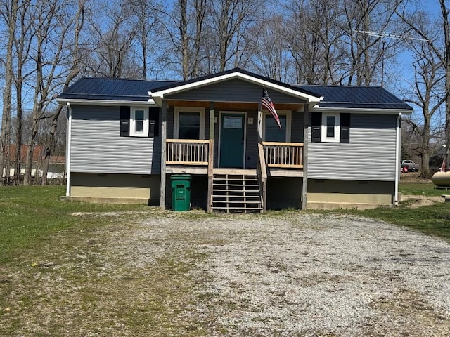 ranch-style home with a porch, stairway, metal roof, and crawl space