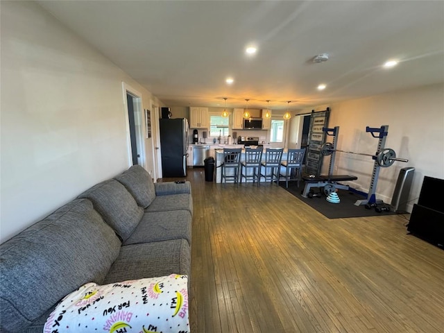living room featuring dark wood-style floors and recessed lighting