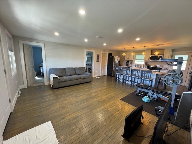 living room with baseboards, dark wood-style floors, and recessed lighting