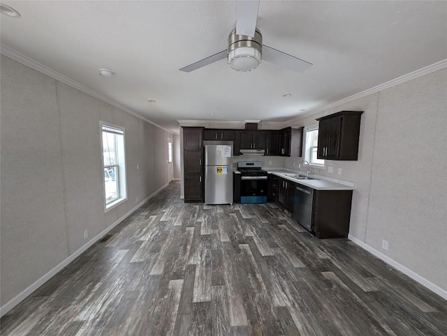 kitchen featuring crown molding, appliances with stainless steel finishes, dark hardwood / wood-style floors, and sink