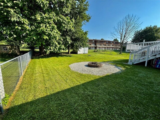 2735 W 35th St, Erie, PA 16506 - view of yard featuring a fire pit, a storage unit, and stairs
