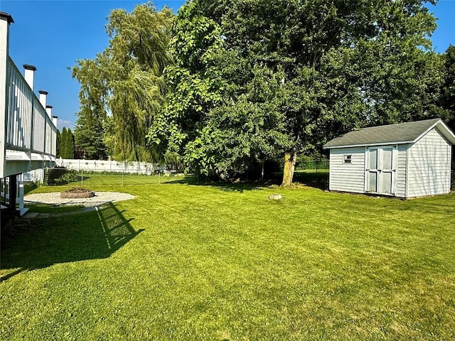 2735 W 35th St, Erie, PA 16506 - view of yard featuring a storage shed, a fire pit, and view of wooded area