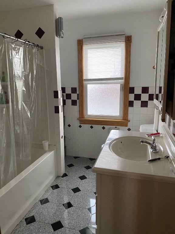 1813 Myrtle St, Erie, PA 16502 - bathroom featuring tile walls, vanity, shower / bath combo, and wainscoting