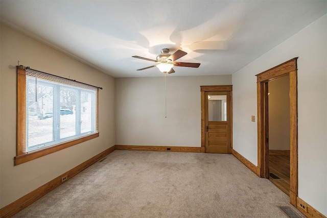 spare room with light carpet and ceiling fan