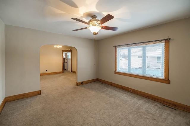 empty room featuring light carpet and ceiling fan