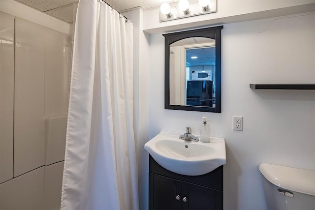 bathroom featuring vanity, toilet, and a shower with shower curtain