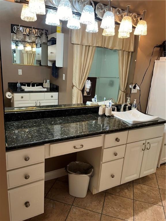 bathroom featuring tile patterned flooring and vanity