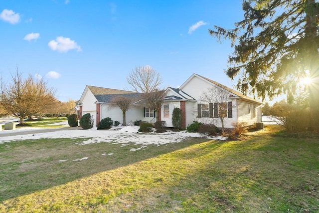 ranch-style home with a garage and a front yard