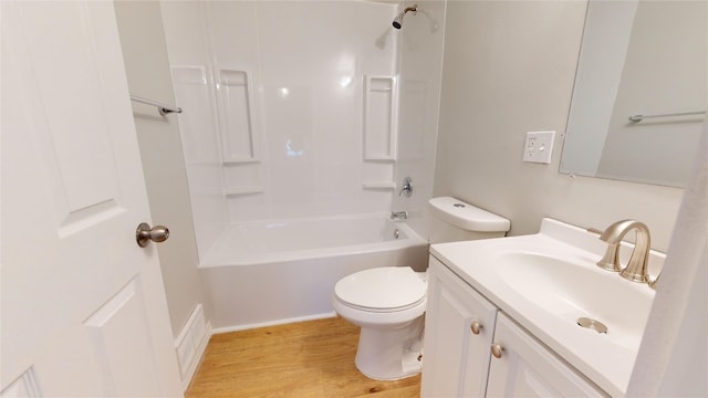 full bathroom with washtub / shower combination, toilet, vanity, and hardwood / wood-style flooring