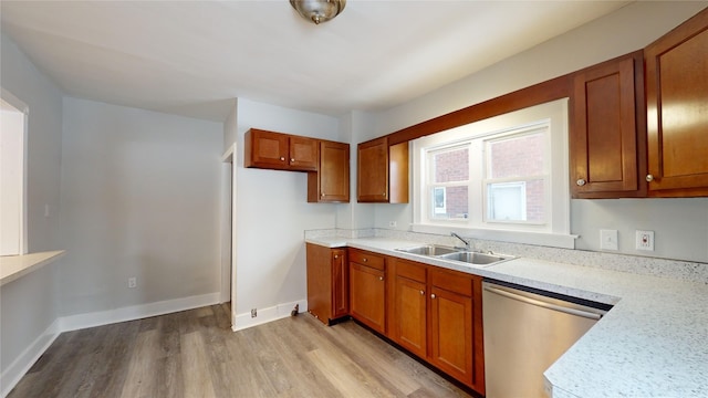 kitchen with dishwasher, light wood-type flooring, and sink