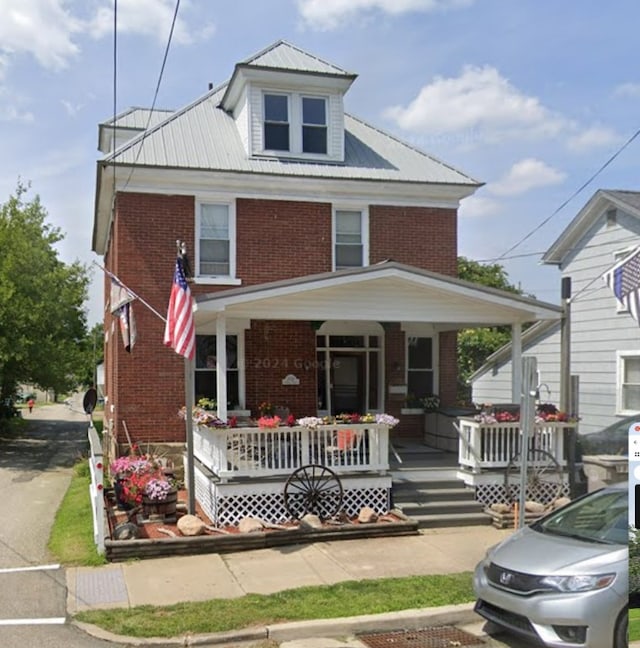 1038 Liberty St, Meadville City, PA 16335 - american foursquare style home with brick siding, a porch, and metal roof