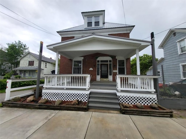 1038 Liberty St, Meadville City, PA 16335 - traditional style home with brick siding, a porch, and metal roof