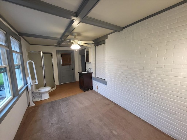 1038 Liberty St, Meadville City, PA 16335 - spare room with coffered ceiling, a wood stove, beamed ceiling, brick wall, and a sink
