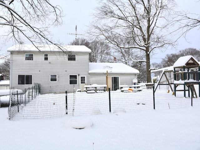 view of snow covered back of property