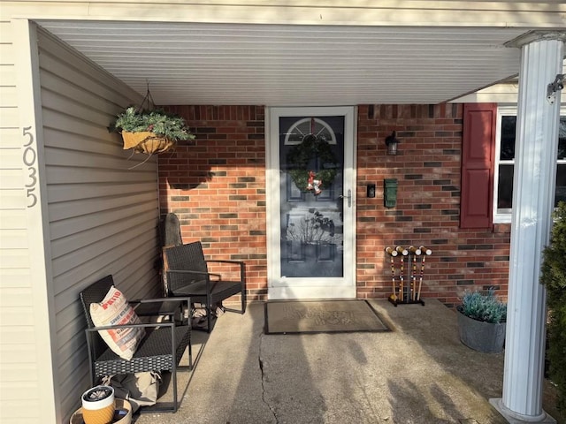 view of exterior entry with brick siding