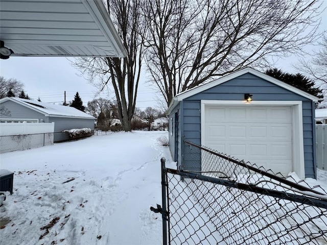 exterior space featuring a garage and an outbuilding