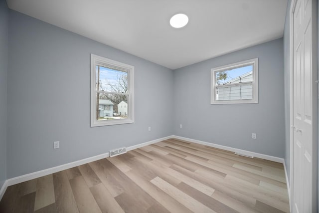 empty room with light hardwood / wood-style floors