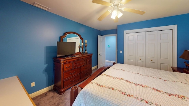 bedroom with ceiling fan, a closet, and dark colored carpet