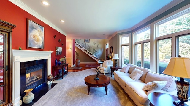 living room featuring carpet flooring, plenty of natural light, and crown molding