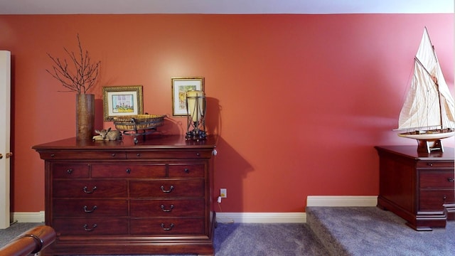 interior space featuring dark colored carpet