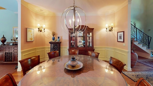 dining area with an inviting chandelier and ornamental molding